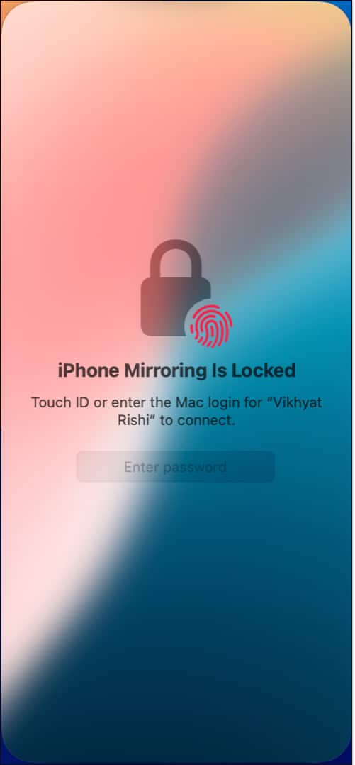 Unlocking the iPhone Mirroring app on a Mac using Mac password or Touch ID.
