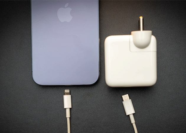 iPhone with charging brick and cable.