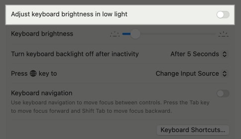 Adjust Keyboard Brightness in Low Light option in MacBook System Settings